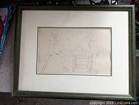 Full view of the framed sketch showing the entire artwork centered inside the frame with visible matting and green wooden frame