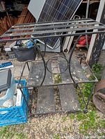 Front view of the custom welded rod iron microwave stand with rectangular top and decorative circular element in the middle.