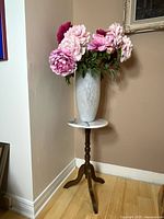 The full setup showing the mahogany tripod pedestal accent table with round marble top holding the vase filled with faux peony flowers.