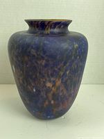 Front view of Karl Schatz signed art glass vase showing mottled blue and orange coloration with flared neck.