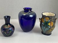 Photo of the three vases side by side showing size and design differences.