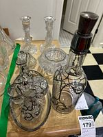 Photo showing two cut glass candle sticks and the glass bowl on a table.