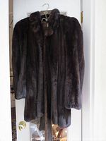 Front view of coat hanging on door