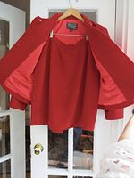 Red wool blend skirt with scalloped edge detail on hem and fully lined interior.