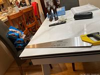 Full view of Stanley JetCut Fine hand saw laid on a table showing the entire blade length and handle.