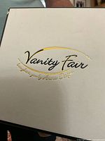 Original Vanity Fair box with gold logo and designer name Arora Design on white box