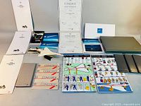 Overview of Concorde ephemera collection including certificates, brochures, tickets, postcards, safety cards, and black folders.