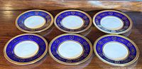 Six Coalport Lady Anne cobalt blue pattern salad plates, arranged on a wooden table.