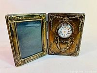 Full view of the hinged desk set opened showing clock on right and photo frame on left with ornate sterling silver and wood construction