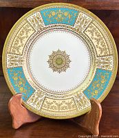 Front view of Minton fine bone china cabinet plate showing full pattern with gold floral designs and turquoise accents.
