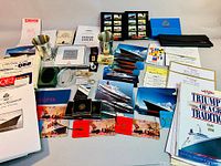 Overview of the entire collection showing the menus, books, postcards, pewter mugs, matchboxes and more, all related to Cunard Line and QE2 ocean liners.