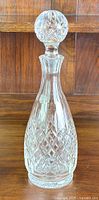 Clear view of the vintage Stuart crystal decanter with round faceted stopper, showing decorative cut patterns.