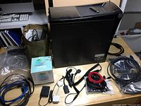 Overview of Acer tower, assorted cables, adapters, speaker dock and USB WiFi adapter