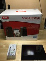Box of RCA Sound System for iPod, iPhone, and iPad, showing packaging and branding.