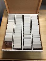 Box open and showing multiple stacks of baseball cards organized in rows.