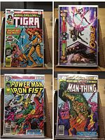 Top view showing comics Tigra, Cable, Power Man & Iron Fist, Man-Thing in protective sleeves