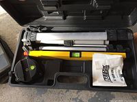 Speedway laser level kit inside black plastic case with tripod and laser level visible