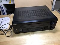 Top and perspective view of Sony stereo receiver showing ventilation and general condition.