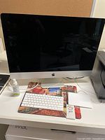 Front view of iMac with keyboard and trackpad on desk
