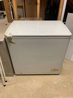 Closed view of the white Danby deep freeze refrigerator showing front and top surfaces with some wear.