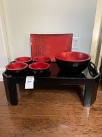 Full set shown on the low table including 1 large bowl, 4 small bowls, and large rectangular plate with Japanese script