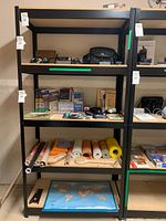 Single black metal shelving unit with four wooden shelves shown with various items on the shelves but not included in sale. Shelving unit dimensions 36x18x72.
