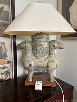 Front view of complete lamp showing shade, metal body and wood base