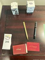 Overhead view of both pens, ink boxes, and guarantee card on tabletop