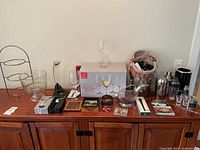 Full table view of wine and cocktail accessories with plate rack, glasses, shakers etc.