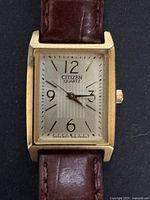 Close-up of the rectangular watch face showing the dial, hands, and Citizen Quartz branding.