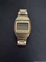 Full view of vintage Seiko watch with stainless steel band, rectangular face, showing wear and scratches