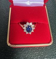 Front view of ring in red presentation box showing overall appearance