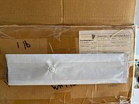 Box with matte white gusseted foil bag with vent valve laid flat showing size marking '1 lb' on the box.