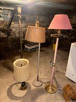 Four lamps in a basement setting: 3 floor lamps and 1 table lamp, with shades including pleated fabric and horse figure