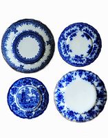 Top view of all four flow blue plates showing patterns and sizes