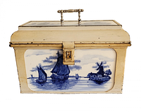 Front view showing porcelain tile with boats and windmills, clasp, handle