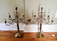 Both brass candelabra lamps side by side