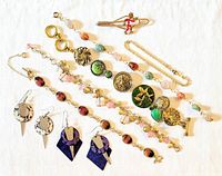All items laid out showing variety of bracelets, earrings and tie clip