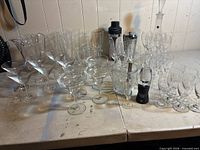 Overview of assorted clear glassware including martini, margarita, pilsner glasses, ice bucket and Brookstone shaker