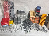 Full lot overview showing hooks, arms, bins, drawers, wire grid and basket