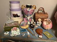 Overall view of assorted porcelain, glass, wicker and wooden items on table