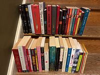 Overview of approximately forty two teen and young adult fiction books lined on two stair steps