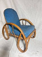 Front angled view showing full chair, rattan frame and blue vinyl seat/back