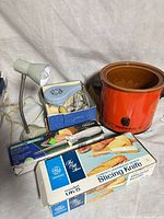 Group shot showing hair dryer in box, Crock-Pot, two GE electric knife boxes, desk lamp