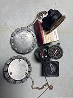 Group shot showing two Kenworth fuel caps, Ekonomix EGT gauge, fuel gauge, Piper gauge, black plastic cap and Kelly Aerospace box