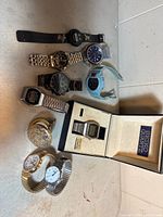 Group shot of all ten watches including Seiko in box and pocket watch