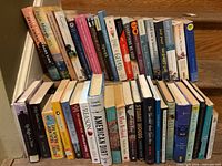 Group of approx. 46 assorted novels on stairs, showing titles and spine conditions