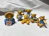Six bear figurines on fabric background