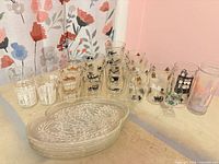 Group view of all glassware including stacked swirl plates and assorted tumblers