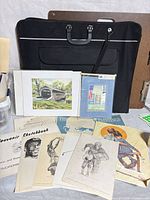 Overall lot showing portfolio, sketchbook and assorted prints